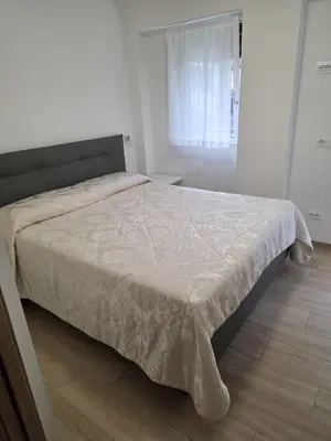 a bedroom with a large bed with a white comforter at Residenza Erica in Moena