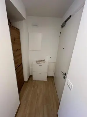 an empty room with a door and a wooden floor at Residenza Erica in Moena