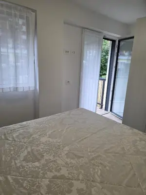 a bedroom with a bed and a large window at Residenza Erica in Moena