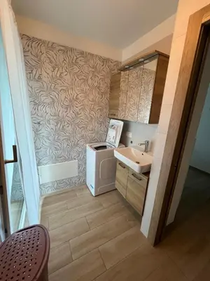 a bathroom with a sink and a washing machine at Residenza Erica in Moena