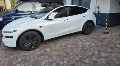 a white electric car is being hydrogenated at Residenza Erica in Moena