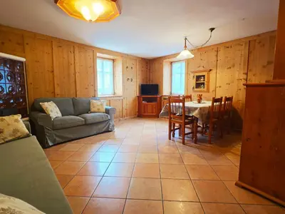 a living room with a couch and a table at La Fata di Moena - Alpine Stay Apartments in Moena