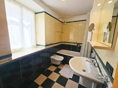 a bathroom with a sink and a toilet at La Fata di Moena - Alpine Stay Apartments in Moena