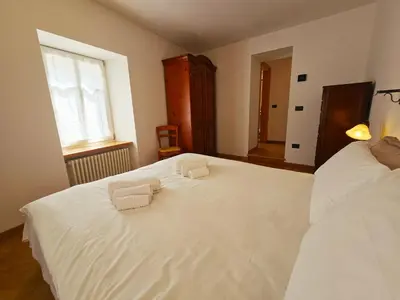 a bedroom with two white beds and a window at La Fata di Moena - Alpine Stay Apartments in Moena