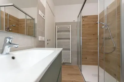 a bathroom with a sink and a shower at Casa Serena in Dolomiti Agordine in Taibon