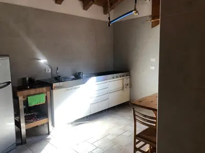 a kitchen with a sink and a table in it at B&B del Mazarol in Canale San Bovo