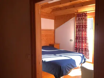 a bedroom with a bed in a room with a window at B&B del Mazarol in Canale San Bovo
