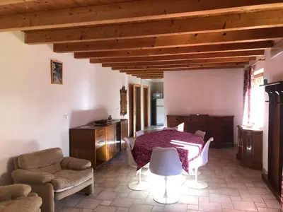 a living room with a table and a couch at B&B del Mazarol in Canale San Bovo