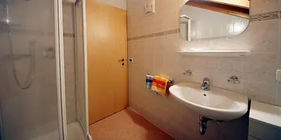 a bathroom with a sink and a shower at Wirthof in La Valle