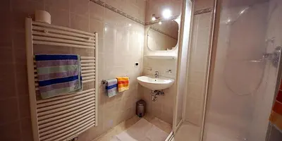 a small bathroom with a sink and a shower at Wirthof in La Valle