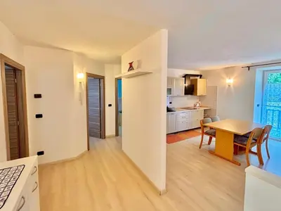 a kitchen and dining room with a table in a room at Appartamento vicino agli impianti Predazzo in Predazzo