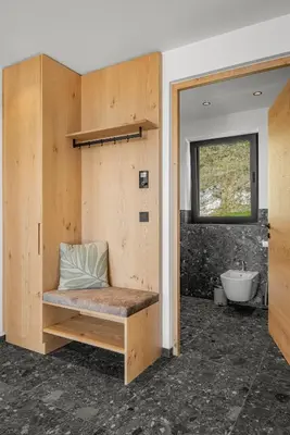a bathroom with a bench with a sink and a tub at Oachner Living in Feldthurns