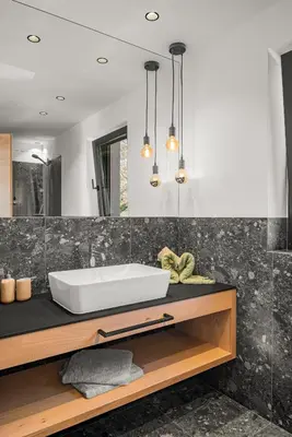 a bathroom with a white tub on a counter at Oachner Living in Feldthurns