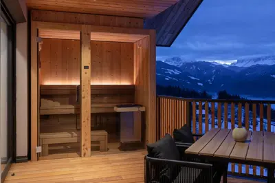 a wooden balcony with a wooden table and a tableasteryasteryasteryasteryasteryastery at Oachner Living in Feldthurns