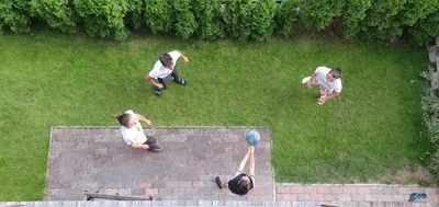a group of people sitting on a wall with a ball at Ciasa Rungger in San Martino in Badia