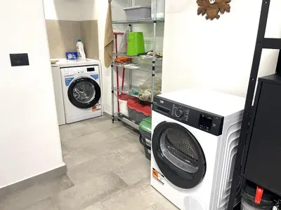 a laundry room with a washer and a washing machine at Appartamento Pineta casa vacanze Sci & Natura in Varena
