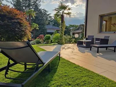 a living room with a blue couch and a table at maia garden - apartment & private garden in Merano