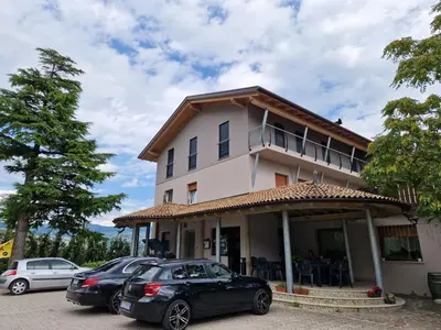 two cars parked in front of a building at Albergo Passione Ristorante Pizzeria Romallo in Romallo