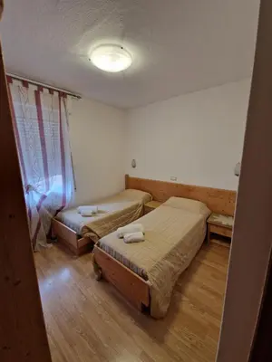 a room with two beds and a window at Albergo Passione Ristorante Pizzeria Romallo in Romallo