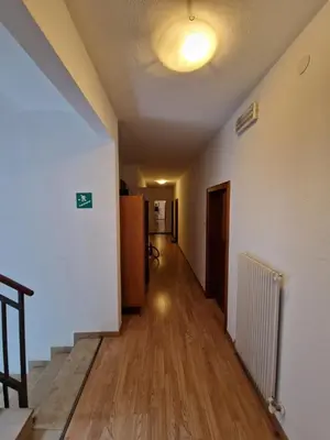 an empty hallway of an apartment with a light on the ceiling at Albergo Passione Ristorante Pizzeria Romallo in Romallo