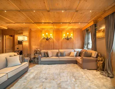 a living room with two couches and a rug at Elegant Tablà with Garden R&R in Cortina dʼAmpezzo