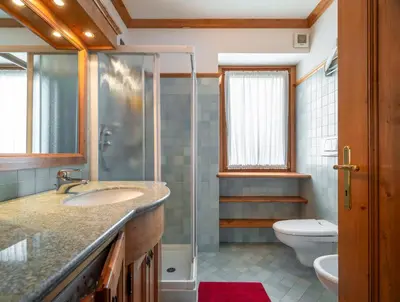 a bathroom with a sink and a toilet at Verocai Charming Chalet R&R in Cortina dʼAmpezzo
