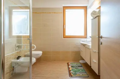 a bathroom with a toilet and a sink at Dimora Kino, Taio Ospitar in Taio