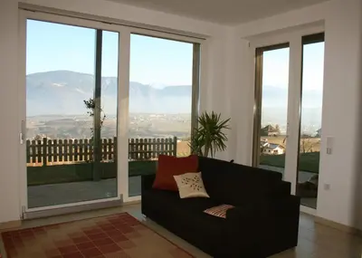 a living room with a couch and large windows at Kreuzsteinhof in San Paolo