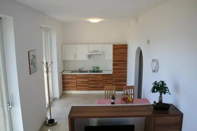 a kitchen and dining room with a table and chairs at Kreuzsteinhof in San Paolo