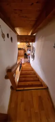 a room with a wooden wall with a clock on it at Pelmo retreat in Villanova