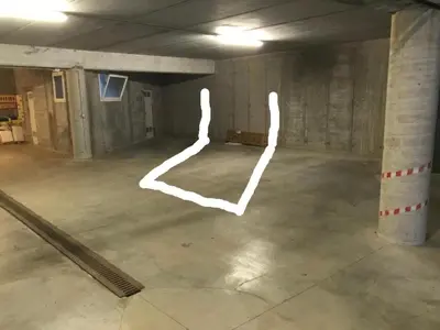 an empty parking garage with white drawings on the floor at Pelmo retreat in Villanova