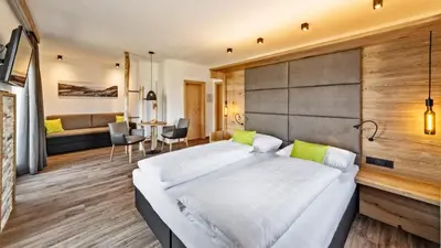 a bedroom with a large white bed in a room at Hotel Garni Sonngart in Andrian