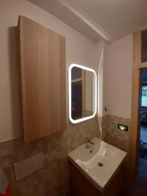 a bathroom with a sink and a mirror at Riccarden Cavalese Centro in Cavalese