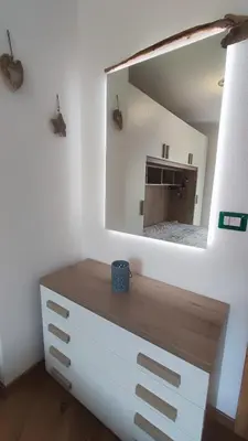 a mirror on top of a dresser in a room at Riccarden Cavalese Centro in Cavalese