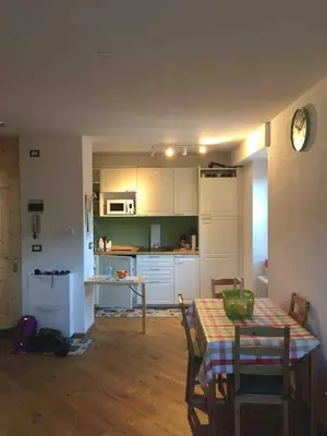 a kitchen and dining room with a table and chairs at Riccarden Cavalese Centro in Cavalese