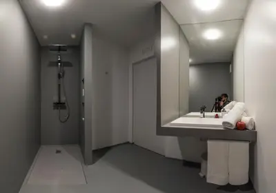 a person taking a picture in a bathroom mirror at NonSoloMele in Romallo