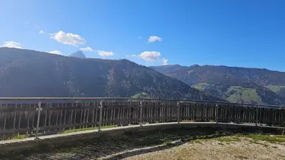 a bridge over a river with mountains in the background at Panorama Dolomiti in San Vigilio Di Marebbe