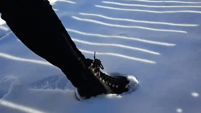 a person wearing black boots in the snow at Panorama Dolomiti in San Vigilio Di Marebbe