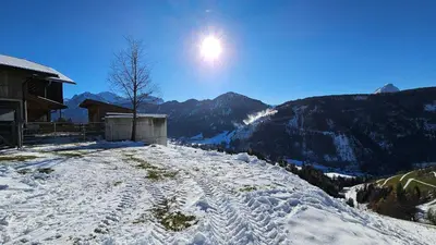 a snow covered mountain with the sun in the sky at Panorama Dolomiti in San Vigilio Di Marebbe