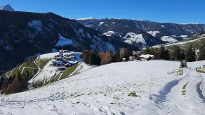 a snow covered mountain with a house on top of it at Panorama Dolomiti in San Vigilio Di Marebbe