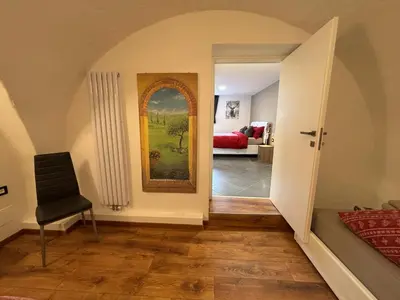 a hallway with a room with a painting on the wall at Casa dei BROCA - Cavalese Val di Fiemme in Cavalese
