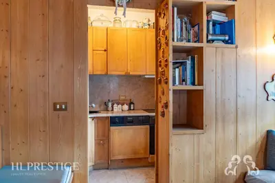 a bedroom with a bed with a wooden headboard at Dolympic View Cortina in Cortina dʼAmpezzo