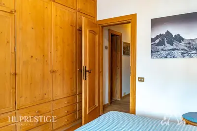 a light on a wooden wall with a picture at Dolympic View Cortina in Cortina dʼAmpezzo