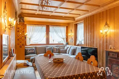 a kitchen with wooden cabinets and a sink at Dolympic View Cortina in Cortina dʼAmpezzo