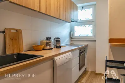 a kitchen with a counter with a sink and a stove at Cà di Bosco Cortina in Cortina dʼAmpezzo