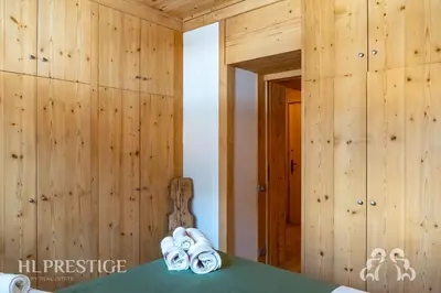 a room with wooden walls and a table with slippers at Dimora del Corso Cortina in Cortina dʼAmpezzo