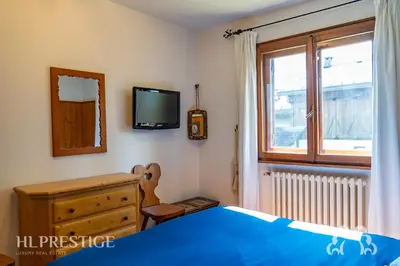 a bunk bed in a room with a ladder at Chalet Boite - Cortina in Cortina dʼAmpezzo