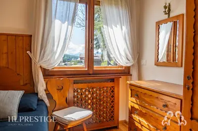 a bedroom with two blue beds and wooden walls at Chalet Boite - Cortina in Cortina dʼAmpezzo
