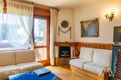 a bed in a wooden room with a window at Chalet Boite - Cortina in Cortina dʼAmpezzo