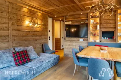 a living room with a couch and a table at Alpenglow Cortina Luxury in Cortina dʼAmpezzo